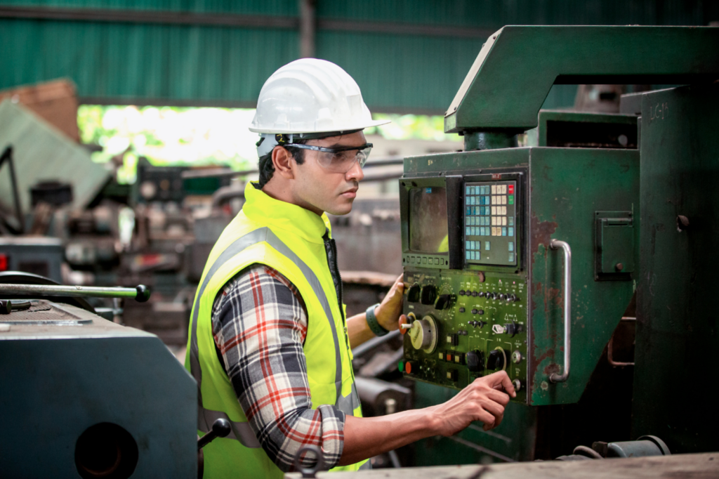 Technician inspecting industrial control panel on a production line experiencing repeated drive failures